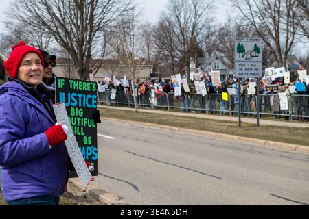 Man carrying No Kings in America flag at Stearne Park, Ludington Michigan, 28 March 2026. Jeffrey Wickett/Alamy Live News